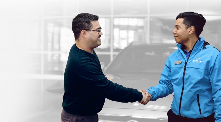 A Citrin team member shaking hands with a dealership service manager