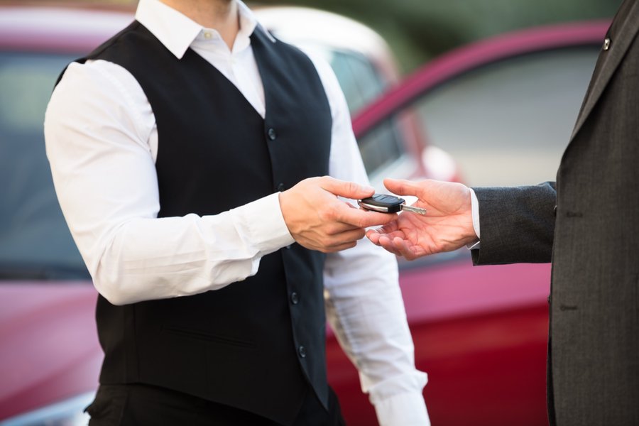 A Citrin valet handing keys to a customer — placeholder