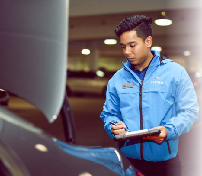 A Citrin team member working the service drive